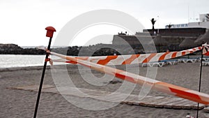 Access to beach deckchair closed by the white and red safety tape due to restrictions for the coronavirus pandemic
