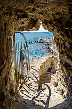 access to the beach through the wall of the fortress in Tossa de Mar