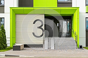 Access to house building number three with glass door, entrance ramp and entryphone photo