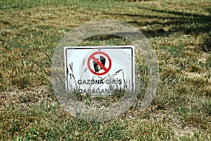 Signboard with the symbol don't walk on the grass . Road stop sign, access prohibited. Do not cross. Prohibition sign on