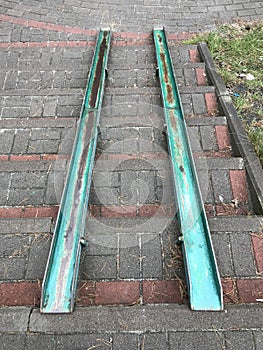 Green slabs of metal allow for wheelchairs or a stroller to pass