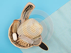 Accessories in the basket for a beautiful and gentle body care on the blue background
