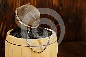 Accessories for brewing tea on a keg on a wooden adored background