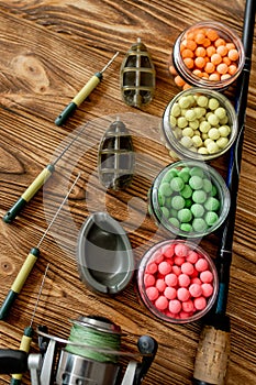 Accessories for carp fishing and fishing baits on wooden planks with copy space
