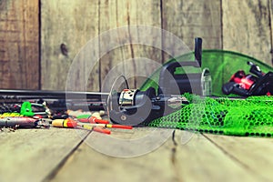 accessories for fishing on a wooden background. selective focus.