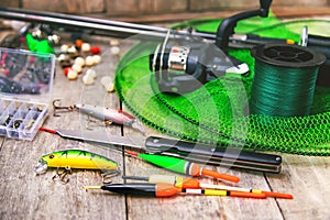 accessories for fishing on a wooden background. selective focus.