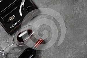 Accessories for oenology. Cup with wine on concrete background. Copy Space