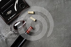 Accessories for oenology. Cup with wine on concrete background. Copy Space photo