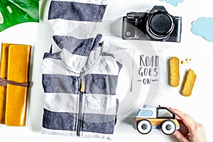 Accessories for treveling with children, camera and suit on whit