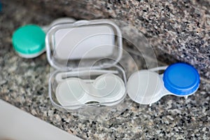 Accessories for working with contact lenses. Tweezers with contact lens and plastic container