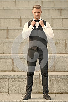 Accessory matters. Gentleman modern style. Guy well groomed handsome bearded gentleman macho adjusting bow tie