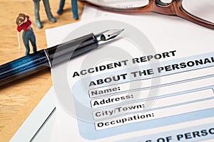 Accident report application form and pen on brown envelope and e