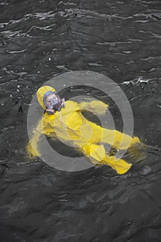 Accident on the sea - worker in protective suit in water
