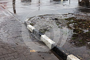 Accident of water supply, sewage. From under the crack in the asphalt poured a water fountain of dirty sewage. Breakthrough