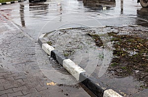 Accident of water supply, sewage. From under the crack in the asphalt poured a water fountain of dirty sewage. Breakthrough