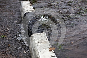 Accident of water supply, sewage. From under the crack in the asphalt poured a water fountain of dirty sewage. Breakthrough