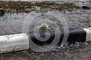 Accident of water supply, sewage. From under the crack in the asphalt poured a water fountain of dirty sewage. Breakthrough