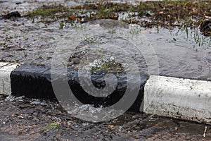 Accident of water supply, sewage. From under the crack in the asphalt poured a water fountain of dirty sewage. Breakthrough