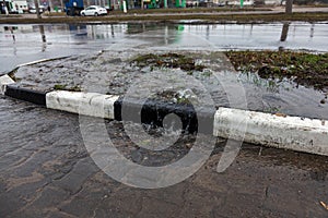 Accident of water supply, sewage. From under the crack in the asphalt poured a water fountain of dirty sewage. Breakthrough