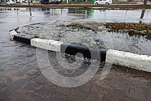 Accident of water supply, sewage. From under the crack in the asphalt poured a water fountain of dirty sewage. Breakthrough