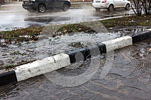 Accident of water supply, sewage. From under the crack in the asphalt poured a water fountain of dirty sewage. Breakthrough