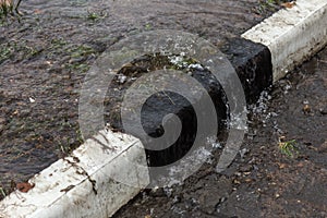 Accident of water supply, sewage. From under the crack in the asphalt poured a water fountain of dirty sewage. Breakthrough