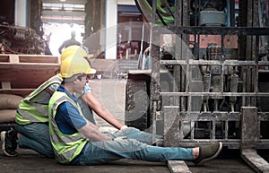 Accident at workplace, industrial engineer worker wearing helmet hit by forklift car at manufacturing plant factory construction