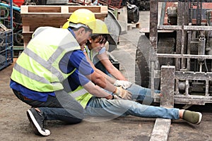 Accident at workplace, industrial engineer worker wearing helmet hit by forklift car at manufacturing plant factory construction