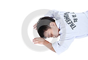 Accidents in sports. Asian child athletes taekwondo lying prone photo
