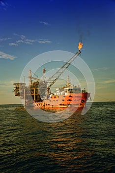 Accommodation work boat attach to oil platform at sea photo