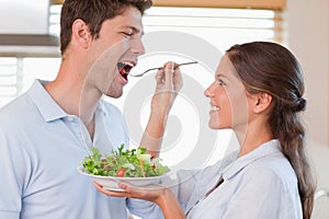 Accomplice couple tasting a salad photo