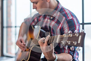 Accord chord, Close up of mens hands playing an acoustic guitar photo