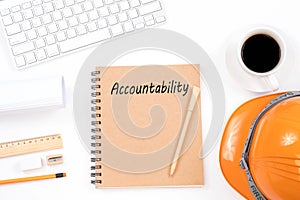 Accountability concept on notebook with modern workplace on whit