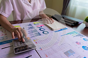 An accountant or businesswoman is calculating statistical graphs about Finance, Company Accounts, Taxes, Income, or Loss