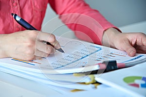 Accountant or businesswoman studying financial report for analysis information