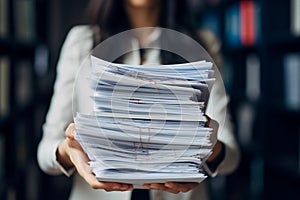 An accountant carries a stack of documents in his hands. A female secretary holds a stack of papers in her hands. Concept: Office