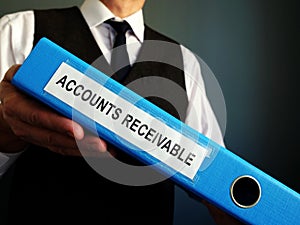 Accountant is holding Accounts Receivable in the folder