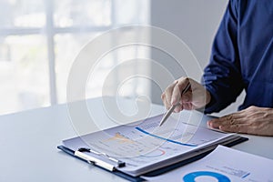 Accountant holding documents preparing performance analysis report Executives create documents