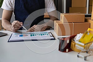 Accountant holding pen and using calculator doing company taxes on wooden table in office tax, accounting,