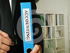 Accountant holds Business Accounting report in the folder