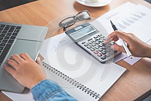 The accountant`s hand is using the calculator. For cost analysis Profit and loss and tax calculation concept preparation of