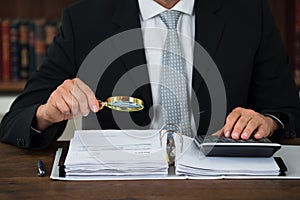 Accountant Scrutinizing Financial Documents In Office