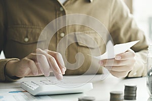 Accountant using calculator for calculate finance report in office.