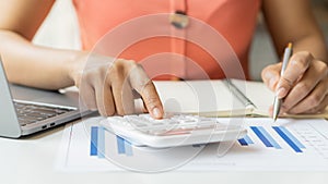 Accountant using computer with clamp and graph document, business man working on desk using calculator to calculate numbers, finan