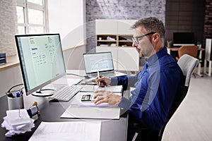 Accountant Using E Invoice Software At Computer