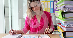 Accountant woman working with papers at the table in modern office
