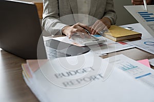 Accountant working discussion and analysis data charts and graphs and using a calculator to calculate numbers. Business