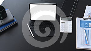 Accountant workplace with computer tablet calculate and business document on black office desk.