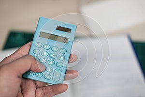 Accountants use the blue calculator to calculate company revenue