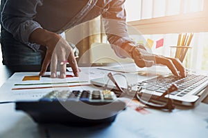 Accountants work analyzing financial reports on a laptop at his